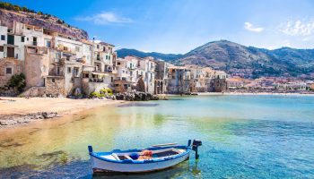 Beautiful old harbor with wooden fishing boat in Cefalu, Sicily, Italy.